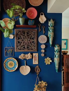 a blue wall with lots of decorative items on it