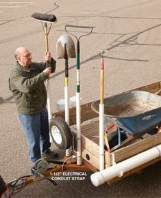 a man is standing next to a wagon with tools on it