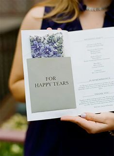 a woman holding up a book that says for happy tears