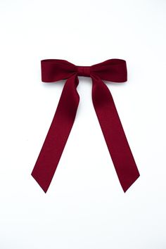 The It Girl Bow! Grace and Grandeur Bow Company’s lovely Florence bow in stunning matte satin ribbon is an accessory staple year round. This bow features beautiful medium length ribbon tails and suits many hair styles.Dimensions The Florence Bow measures approximately 5.5" wide and tails are approximated 7.5" long from top of bow to longest tip. This bow is secured on a 3" barrette.* Luxe Matte Satin Ribbon* Classic Bow * French Barrette* Size | 5”W x 6”L* Grandmillennial StyleMade in the USA*Pl Red Bow Aesthetic, Red Bow In Hair, Red Hair Bow, The It Girl, Bow Organizer, Satin Ribbon Bow, Hair Ribbon