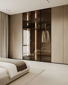 a bedroom with a bed and closets next to a large glass doored window