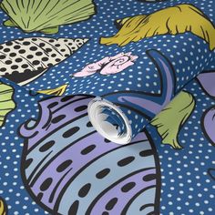 a blue and white wallpaper with colorful fish on it's surface, along with polka dots