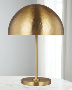 a large brass lamp on a white table