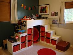 a child's bedroom with red and white storage bins on the bottom shelf