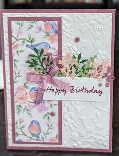 a birthday card with flowers and birds on it