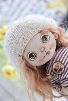 a close up of a doll wearing a hat