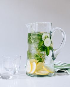 a pitcher filled with cucumber and lemon slices