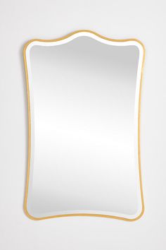 an empty white mirror with gold trim around the edges