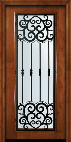 a wooden door with wrought iron designs on it