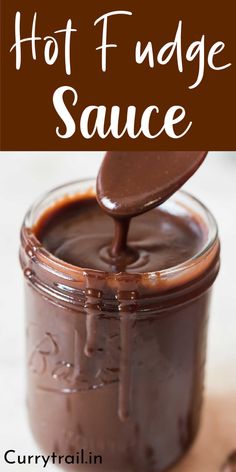 hot fudge sauce in a glass jar with a spoon sticking out of the top