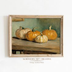 a painting of three pumpkins on a table with the caption northern art creative