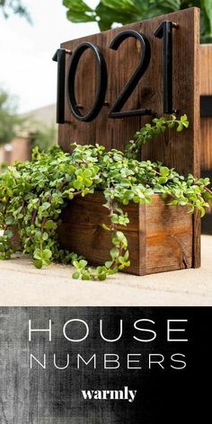 a wooden house number sign sitting on top of a table