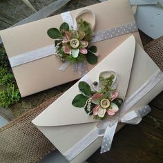 two boxes are decorated with flowers and ribbons