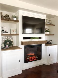 a living room with a fireplace and entertainment center