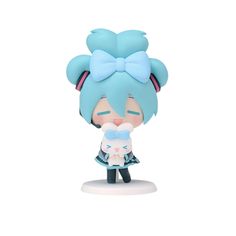 a small figurine with a blue hair and bow on it's head