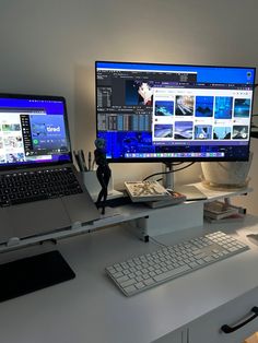 two laptops are sitting on a desk next to a computer monitor and keyboard in front of it