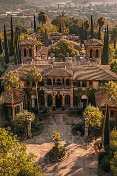 an aerial view of a mansion surrounded by trees