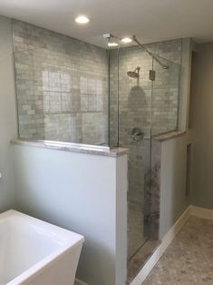 a bathroom with a walk in shower next to a bathtub