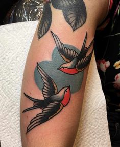 a couple of birds that are on the arm