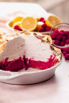 a dessert with raspberries and lemons on the side