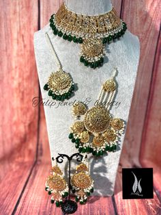 a necklace and earring set with green beads