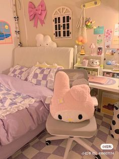 a bed room with a neatly made bed and a hello kitty chair