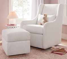 a white chair and footstool in a pink room with a teddy bear on the floor