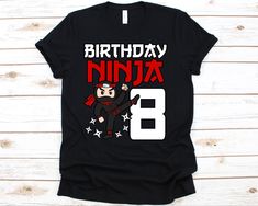 a black shirt with an image of a ninja on the front and number 8 on the back