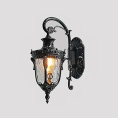 an old fashioned wall light with two lights on it