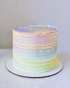 a multicolored cake sitting on top of a white plate