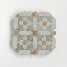 a white and brown tile design is shown on the wall in this photo, it appears to be made out of paper