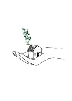 a hand holding a small house with a plant growing out of it's roof