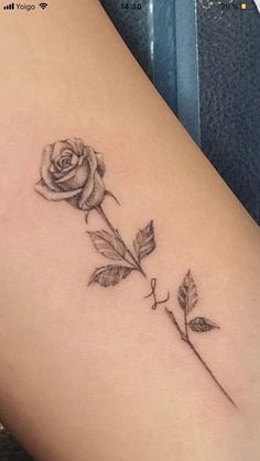 a small rose tattoo on the leg