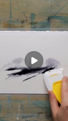 someone is using a video to paint a piece of paper with black and white ink