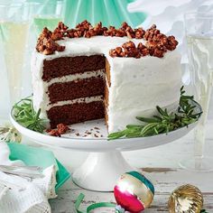 there is a cake with white frosting and walnuts on it