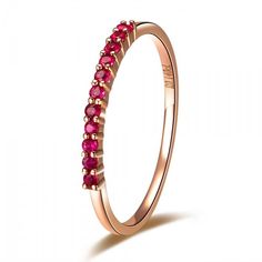 a pink gold ring with red stones on the inside and outside, set in 18k rose gold