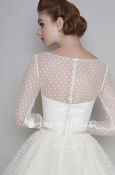 the back of a woman's wedding dress with white polka dots on it,