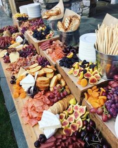 a table filled with assorted fruits and breads on it's sides for sale