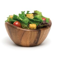 a wooden bowl filled with lettuce and tomatoes