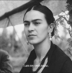 a black and white photo of a woman with an earring on her left ear