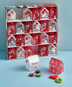 a red and white christmas display case with gingerbread houses, candy canes and candies