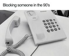 an old phone sitting on top of a table next to a corded telephone with the words blocking someone in the 90's