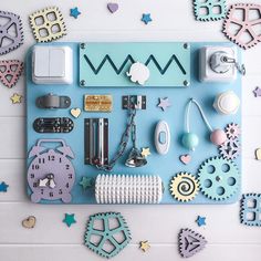 an assortment of items are displayed on a blue board with stars and shapes around it