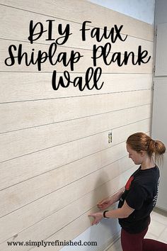 a woman is painting a wall with black lettering that says diy faux shiplap plank wall