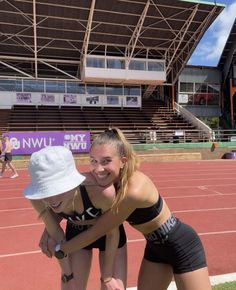 two women on a tennis court hugging each other