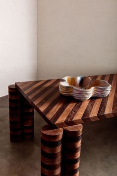 a wooden table with three bowls on it