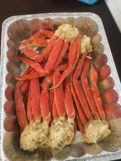 some crab legs and potatoes are on a tray