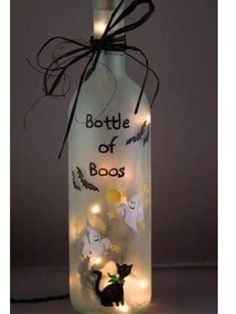 a bottle that has some lights in it and is decorated with halloween decorations on the inside