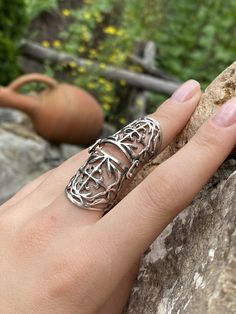 It is designed so as not to interfere with the finger movements, and you will want to wear it all day long. Armor full finger Ring shield ring sterling silver armor ring Knuckle joint ring Vintage armor ring Full finger long ring Armenian silver Worldwide tracked shipping 3-5 weeks NOTE. Please choose your exact size , as the band is wide we make it a bit larger For more Double rings chech here https://www.etsy.com/listing/862258018/double-ring-chain-ring-double-chain-ring?ref=shop_home_active_1 Finger Gauntlet Ring, Metal Finger Claws, Finger Armor Ring, Medieval Silver Rings For Larp, Silver Armor, Full Finger Ring, Christian Cross Necklace, Pomegranate Earrings, Armor Ring