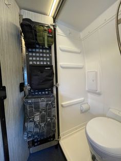 the interior of an airplane bathroom with toilet, sink and storage area for items to be placed in